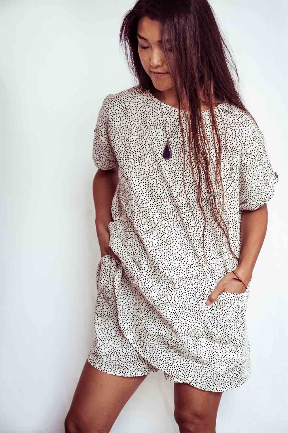 Woman wearing a patterned dress against a white background