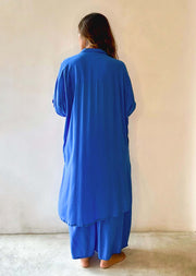 Person wearing a blue outfit against a plain background