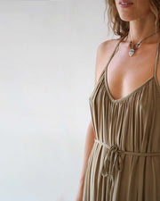 Woman wearing a beige dress with a white background