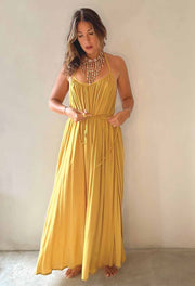 Woman wearing a yellow dress against a plain background