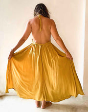 Woman wearing a yellow dress with a plain background