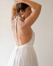 Woman wearing a white dress with a minimal background