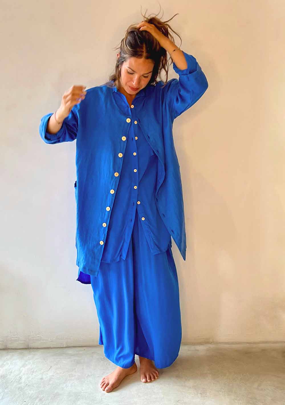 Person wearing a blue traditional outfit with a plain background