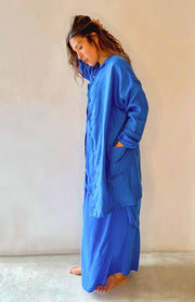 Woman wearing a blue outfit against a plain background