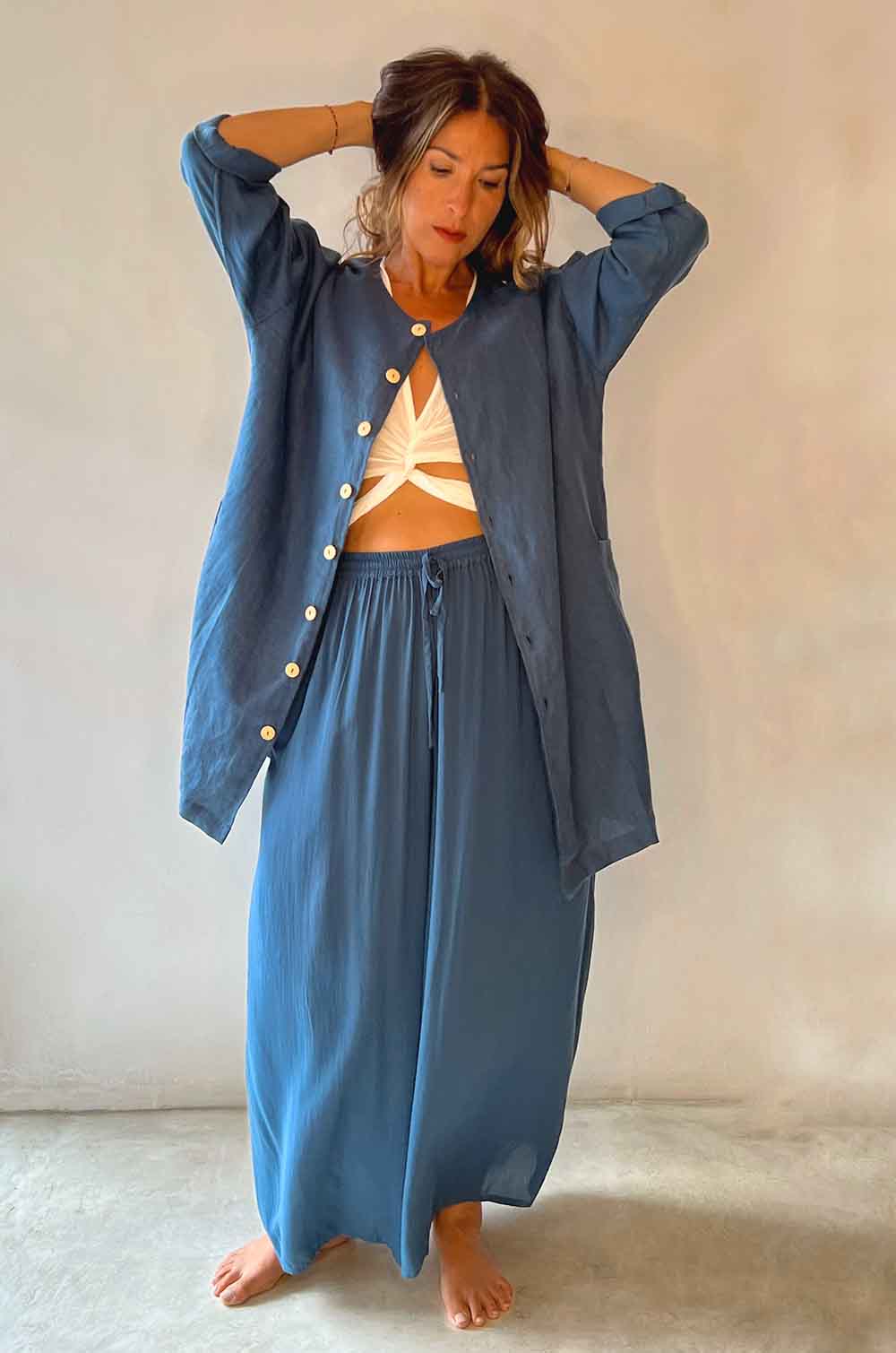 Woman wearing a blue outfit with a white background