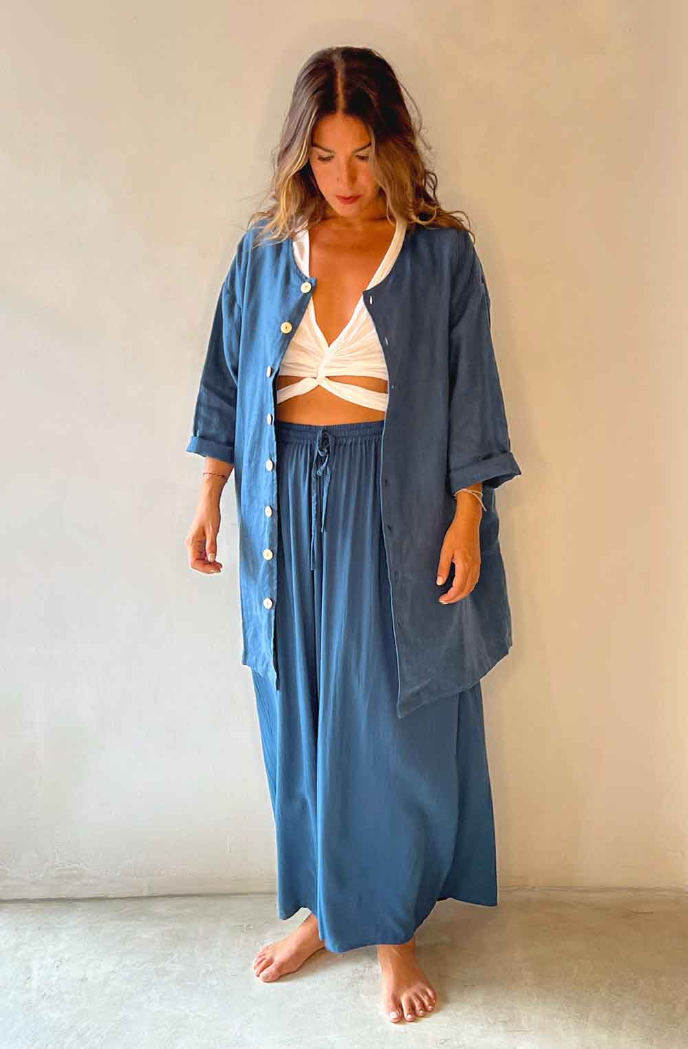 Woman wearing a blue outfit with a white background