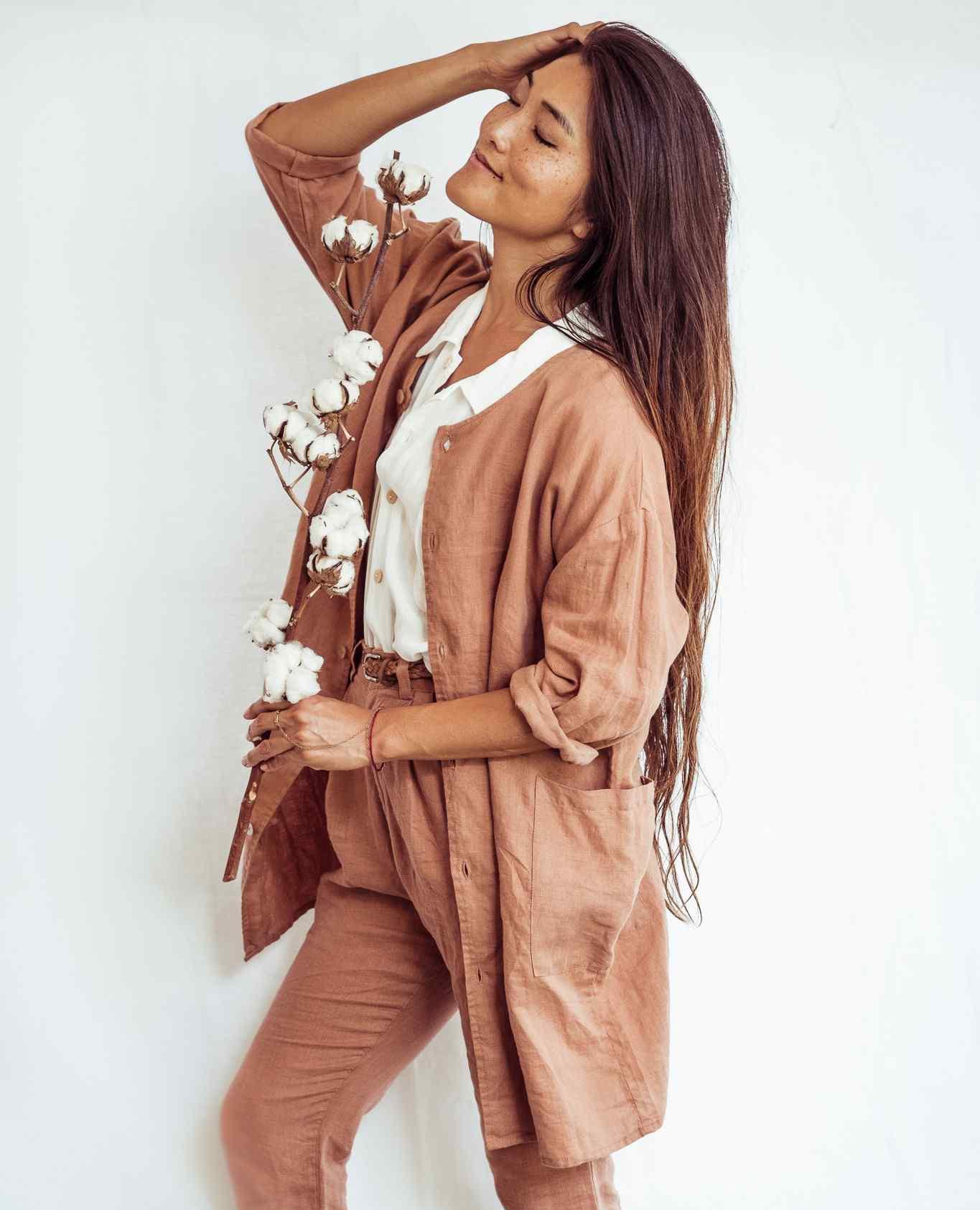 Woman wearing a brown outfit with a white background
