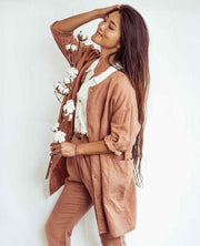 Woman wearing a brown outfit with a white background