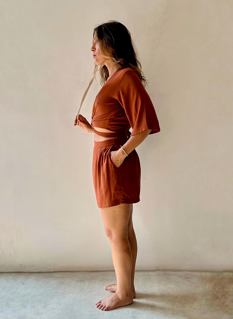 Woman wearing a brown outfit against a plain background