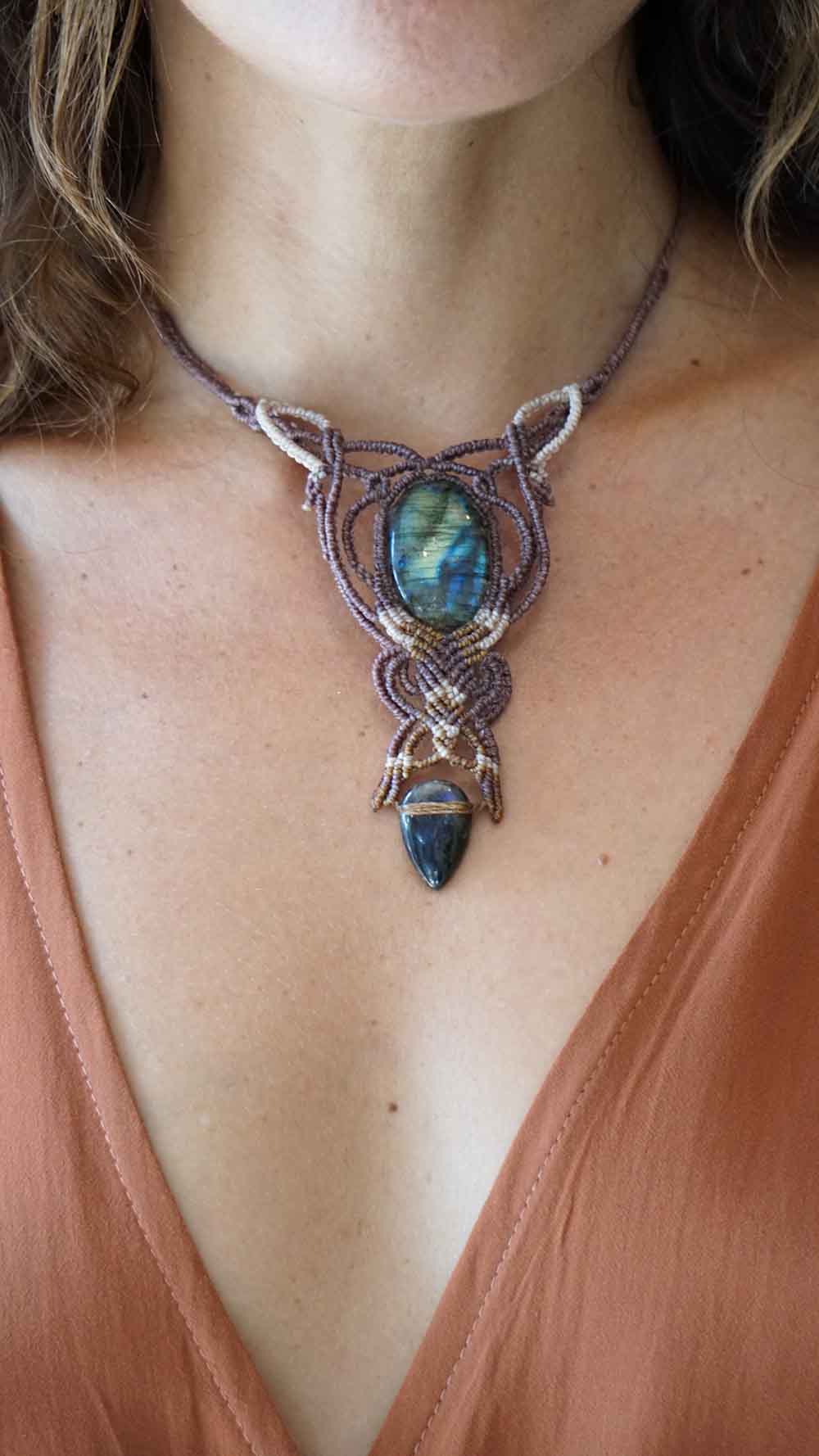 Necklace with a Labradorite stone worn by a person