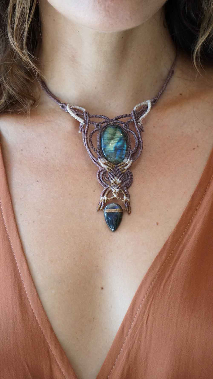 Necklace with a Labradorite stone worn by a person