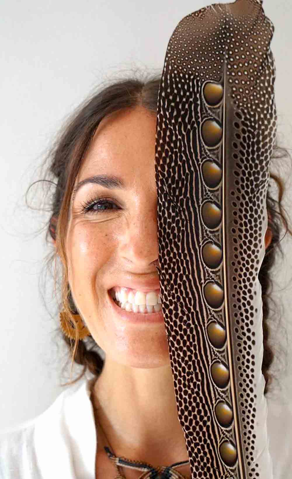 Woman smiling with a decorative headband covering her face
