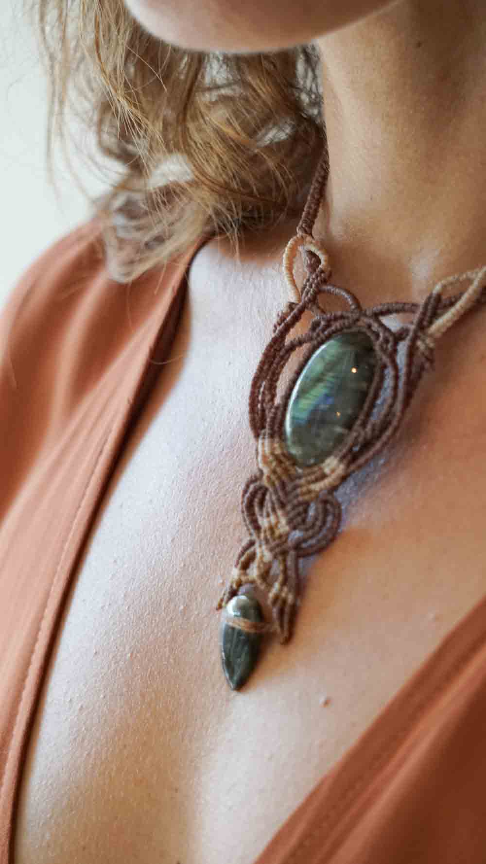 Necklace with a green stone pendant worn by a person