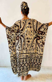 Person wearing a black and white patterned dress with a plain background