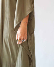 Person wearing a green garment with a white background
