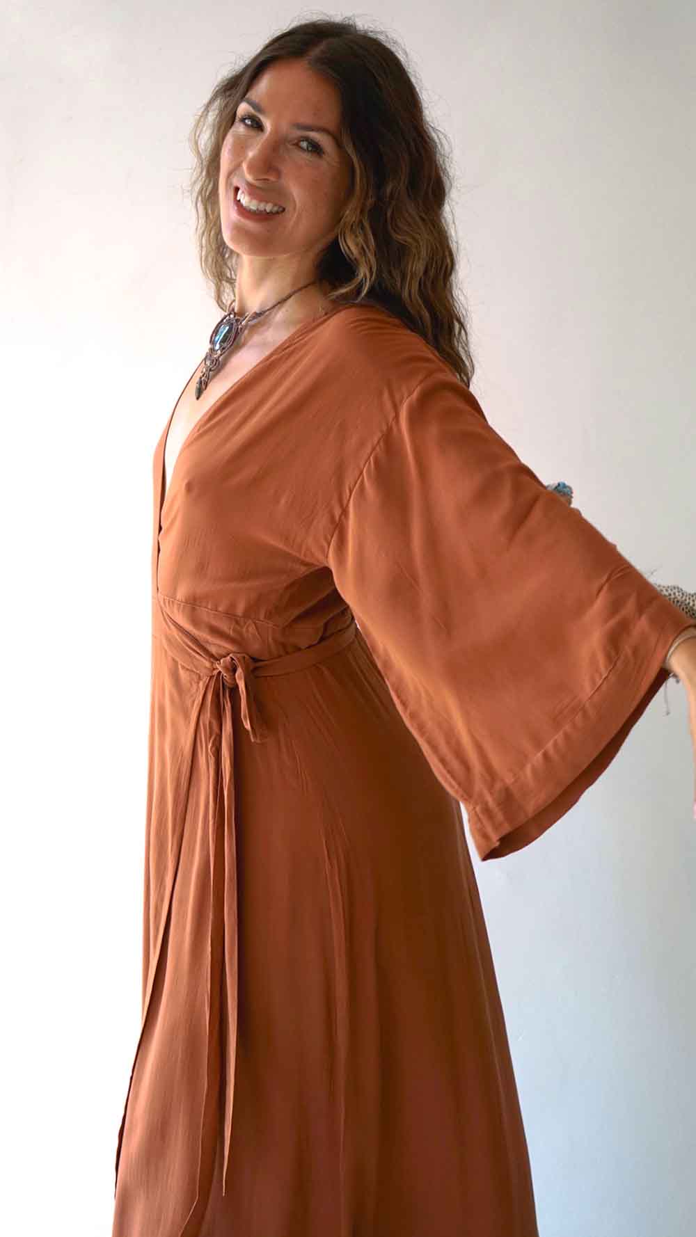 Woman wearing a brown dress with a plain background