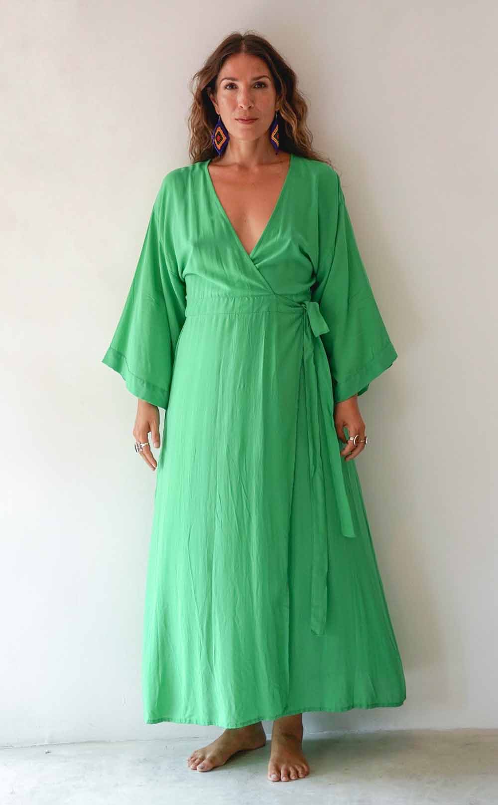 Woman wearing a green dress against a white background