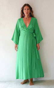 Woman wearing a green dress against a white background