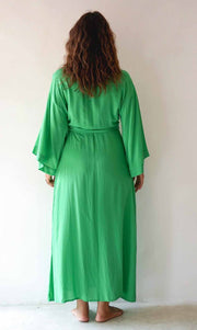 Person wearing a green robe against a white background