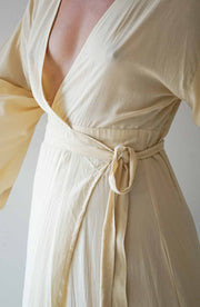 Beige dress with a belt on a plain background
