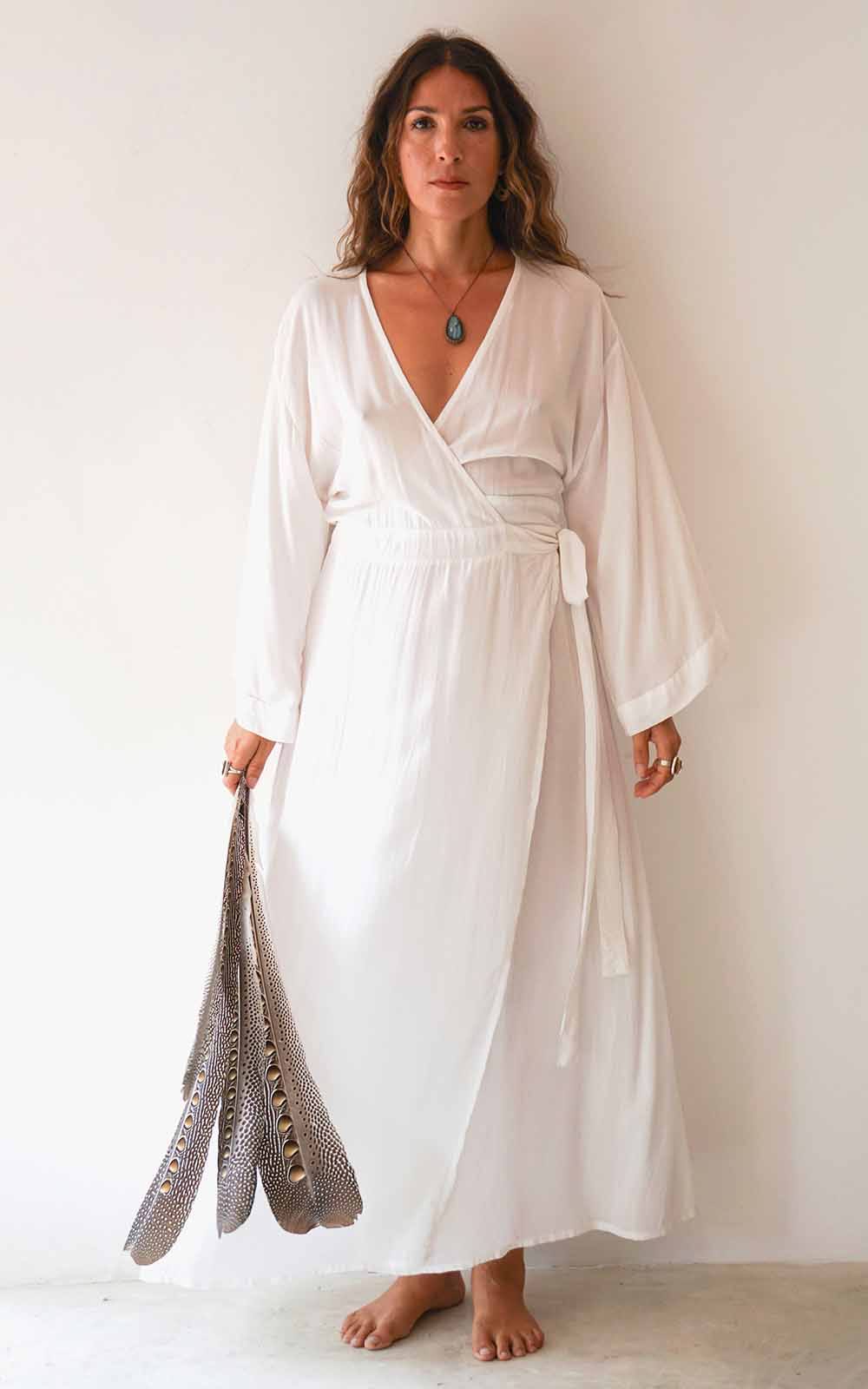 Woman wearing a white dress against a plain background