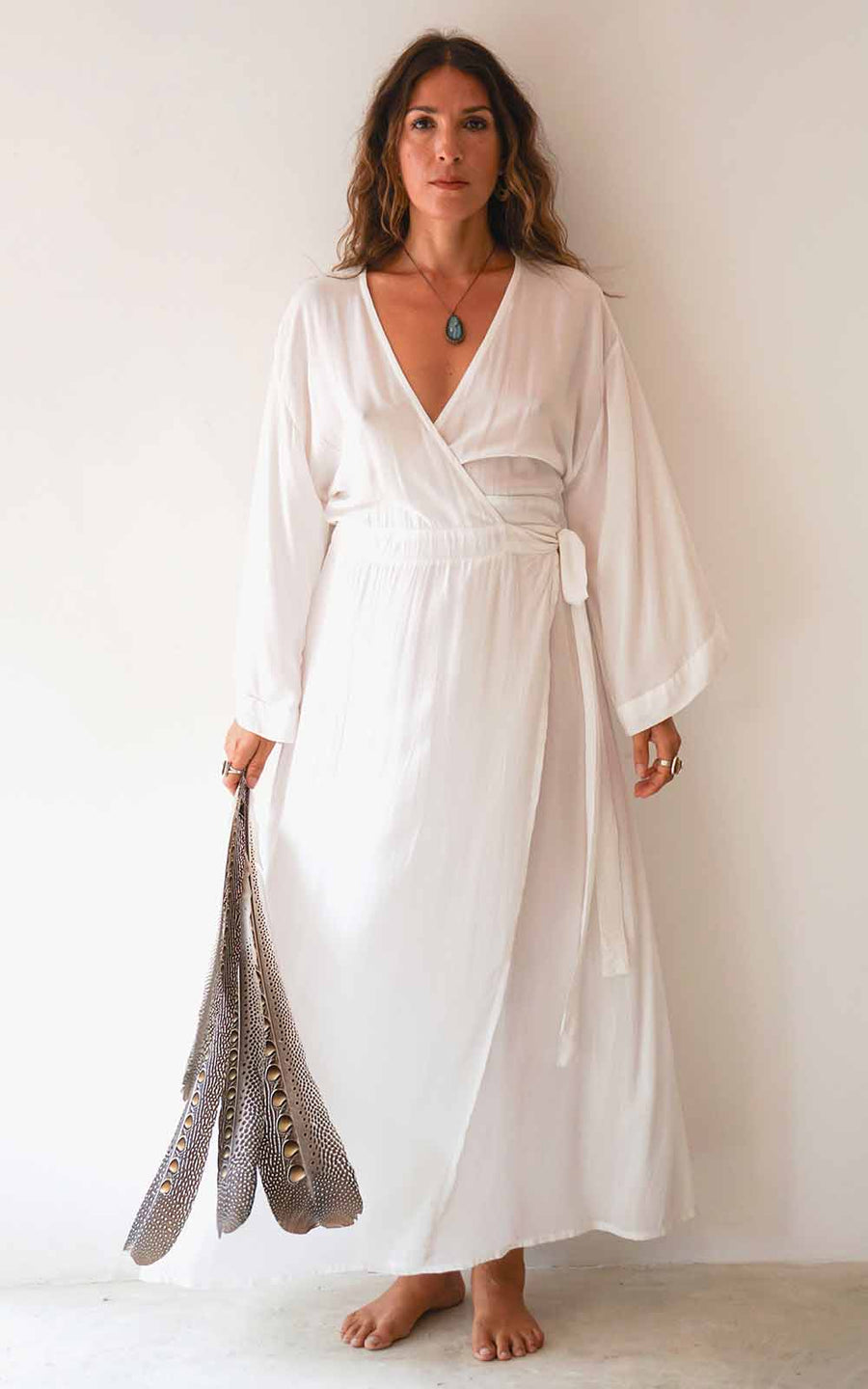 Woman wearing a white dress against a plain background