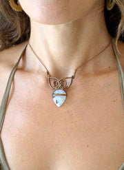 Necklace with a heart-shaped pendant worn by a person