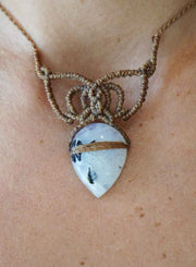Necklace with a heart-shaped stone pendant on a person's neck