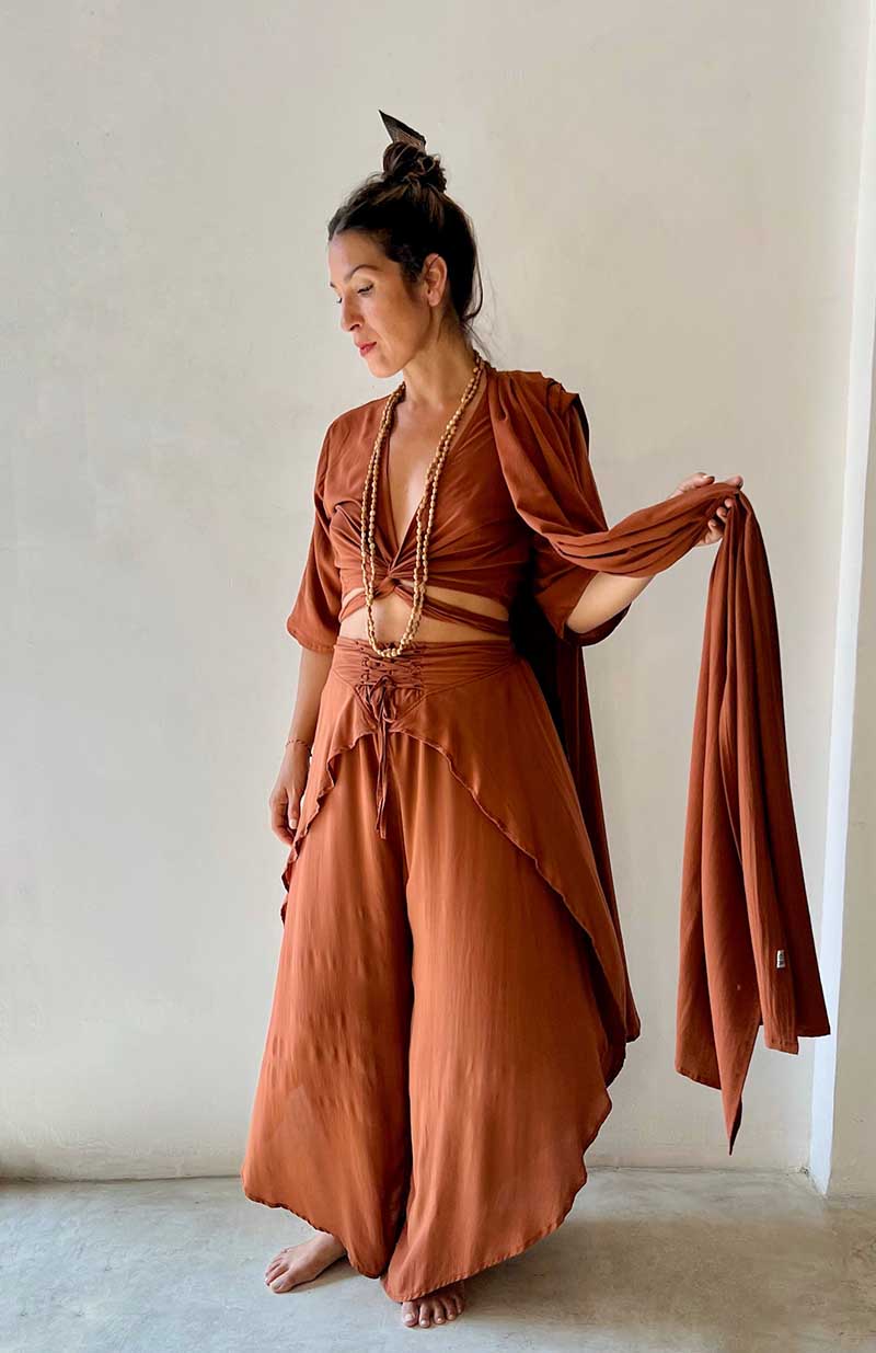 Woman wearing a brown outfit with a plain background