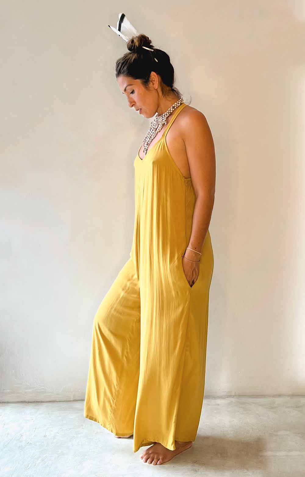 Woman wearing a yellow dress against a plain background
