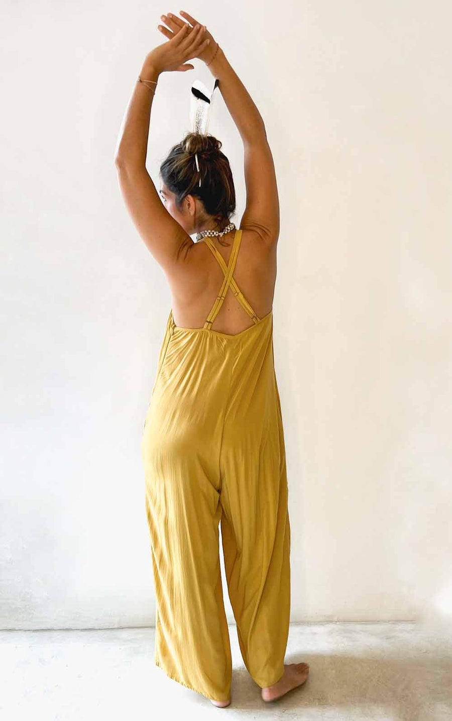 Person wearing a yellow jumpsuit with a white background