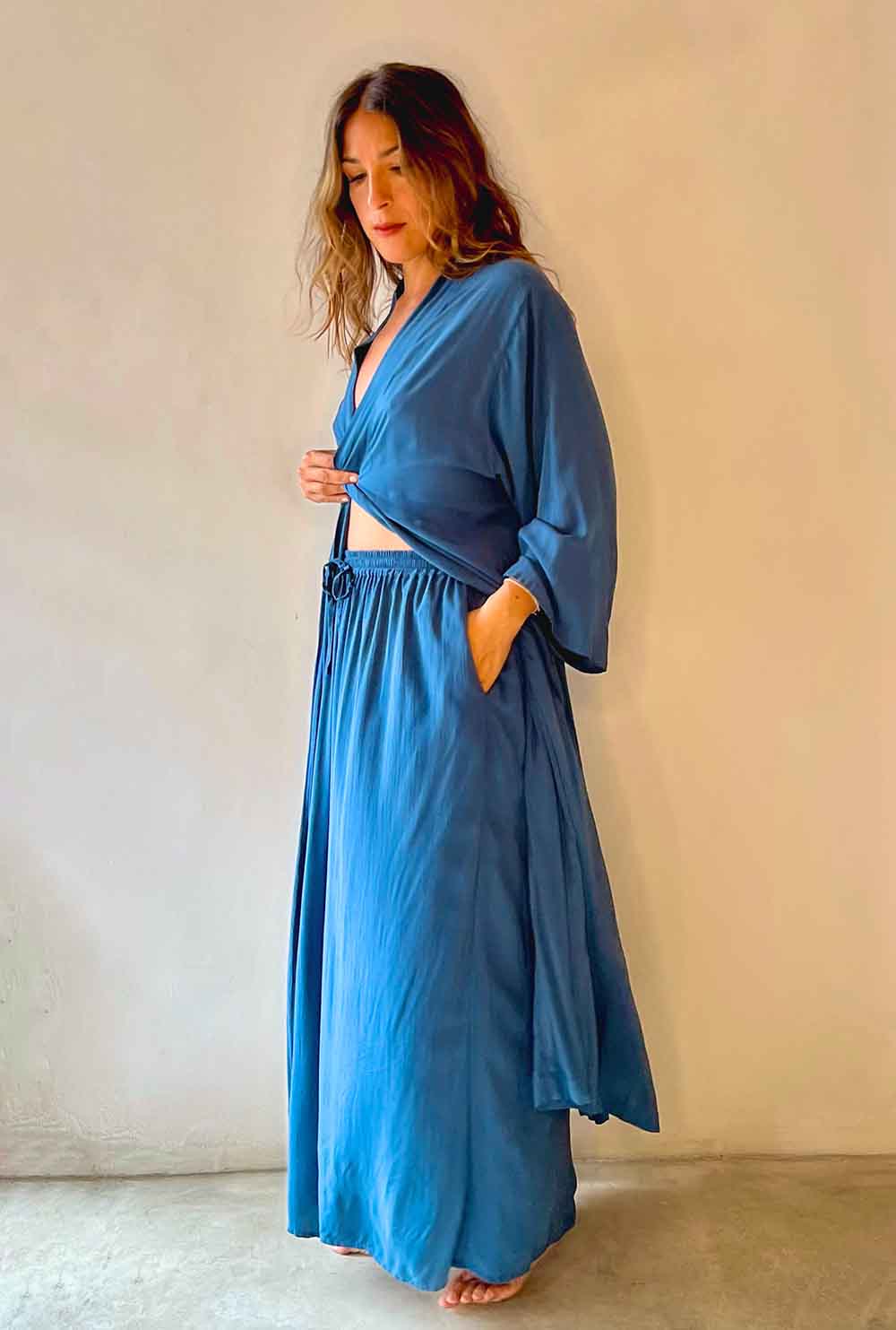 Woman wearing a blue outfit against a plain background
